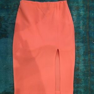 Astr bright creamsicle colored fitted midi skirt.